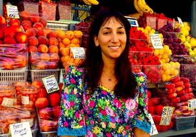 Emily Sigman, MF/MA '21, exploring Saint Petersburg's bustling fruit markets. Emily is spending the summer in Russia studying Advanced Russian with the Yale Summer Session, and conducting research on Saint Petersburg's unique, multicultural and perennial fruit markets. Behind Emily is a stand containing fruits from Central Asia. Her research aims in part to untangle the myriad ways both the fruits and the people selling them come to Saint Petersburg.