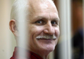 Ales Bialiatski headshot behind prison bars